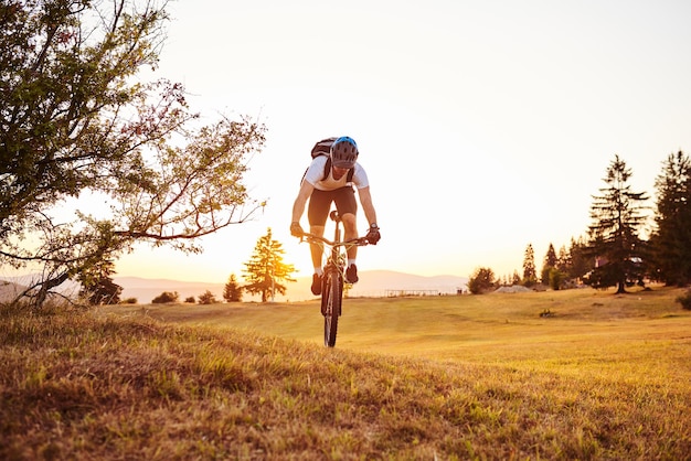 Cyclist Riding the Bike on the Trail in the Forest Man cycling on enduro trail track Sport fitness motivation and inspiration Extreme Sport Concept Selective focus