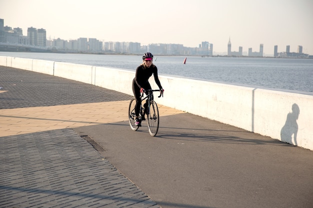 Cyclist training on the waterfront of the city