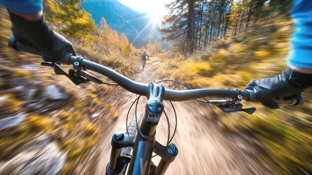 Cyclists perspective on a fast mountain bike ride through an autumn forest trail showing handlebars and motion blur for dynamic effect