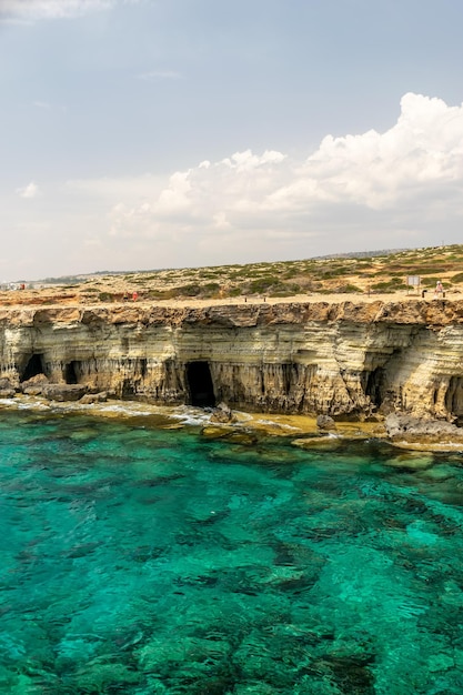 CYPRUS AYA NAPA Tourists stroll along the coast near the picturesque sea caves