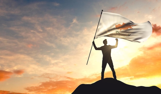 Cyprus flag being waved by a man celebrating success at the top of a mountain 3D Rendering