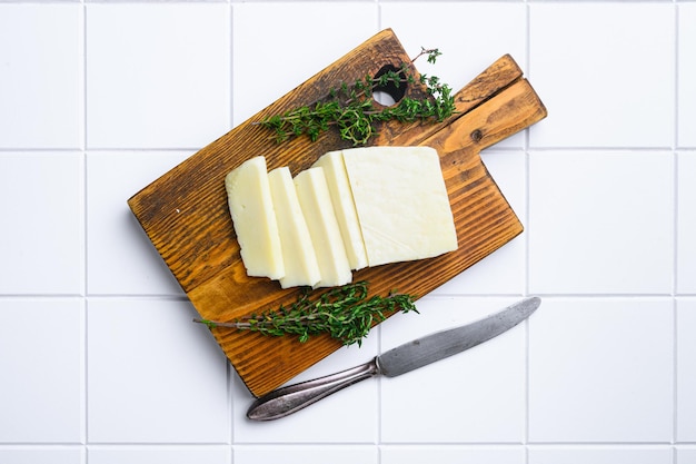 Cyprus Halloumi cheese set on white ceramic squared tile table background top view flat lay with copy space for text