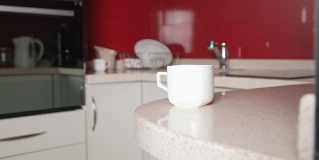 Ð¡ontemporary kitchen table with a white coffee cup.