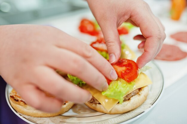 Ð¡ooking burgers in the kitchen at home during quarantine time.