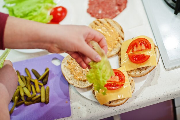 Ð¡ooking burgers in the kitchen at home during quarantine time.