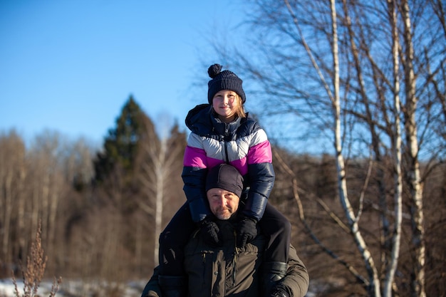 Dad carries daughter on shoulders