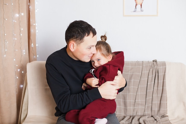 Dad and Daughter Blue Eyed European Playing By A Decorated Christmas Tree