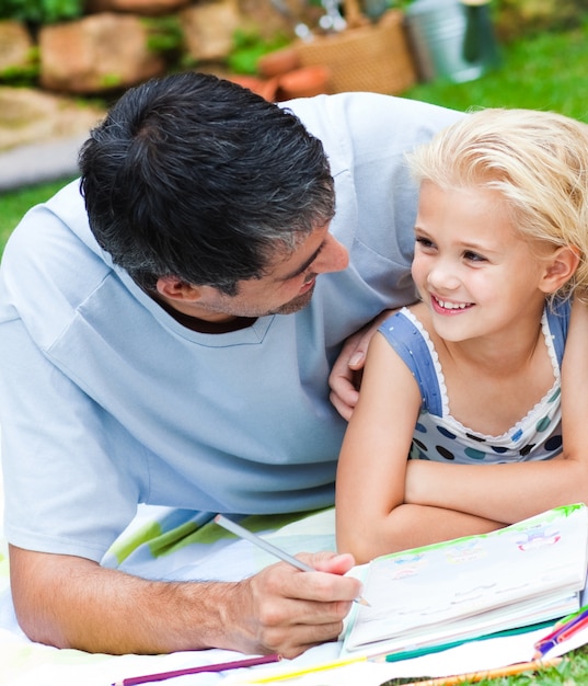 Dad and daughter doing homework in a garden