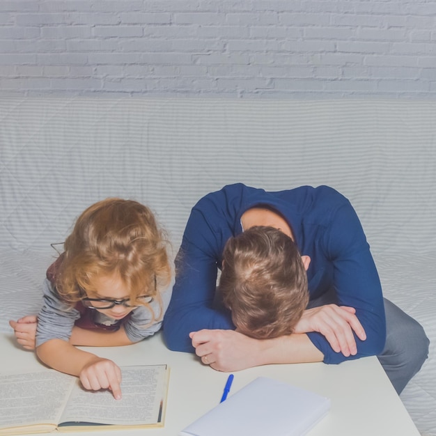 The dad and daughter do homework after primary school