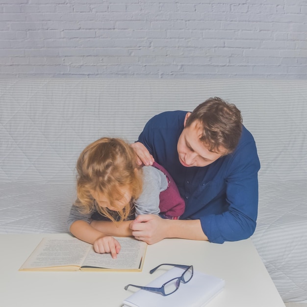 The dad and daughter do homework after primary school