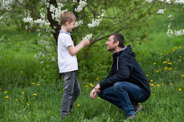 Dad is sitting next to the child and talking to him