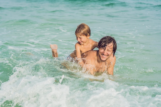 Dad plays with his son in the sea