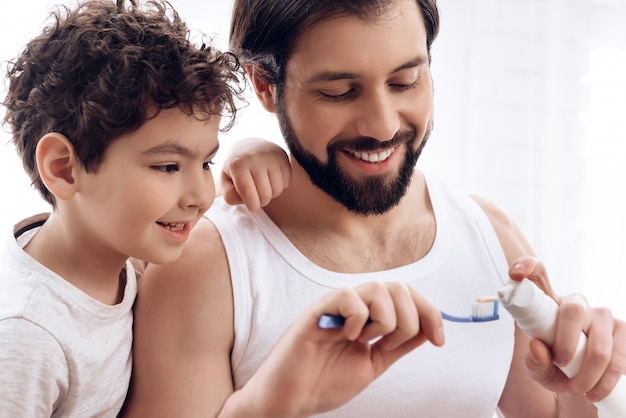 Dad shows you how to squeeze the paste.