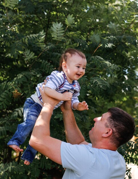 Dad and son have fun in the park on a sunny summer day Fathers day fatherhood