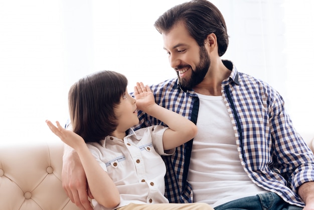 Dad and son at home have fun together.