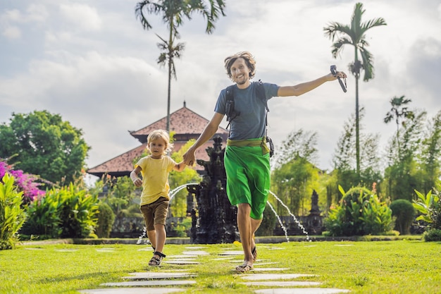 Dad and son tourists in Traditional balinese hindu Temple Taman Ayun in Mengwi. Bali, Indonesia Traveling with children concept