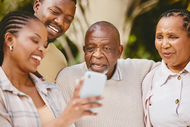 Dad takes selfies until he finds the perfect one. Shot of a woman showing her parents something on her cellphone.