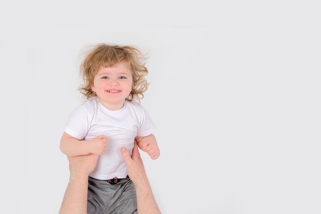 Dad throws a laughing child up white background copy space high quality photo