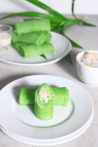 Dadar Gulung or Dadar Unti is Indonesian finger food is grated coconut sweetened with palm sugar