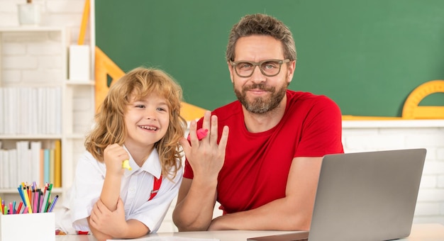 daddy and son study in classroom with laptop, online education.