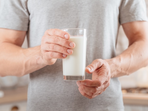 Dairy products. Balanced nutrition. Cropped shot of man holding glass of soy milk.