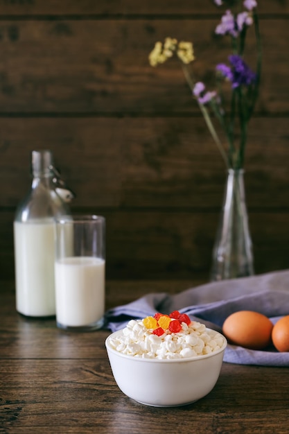 Dairy products on dark wooden table sour cream milk cheese egg selective focus