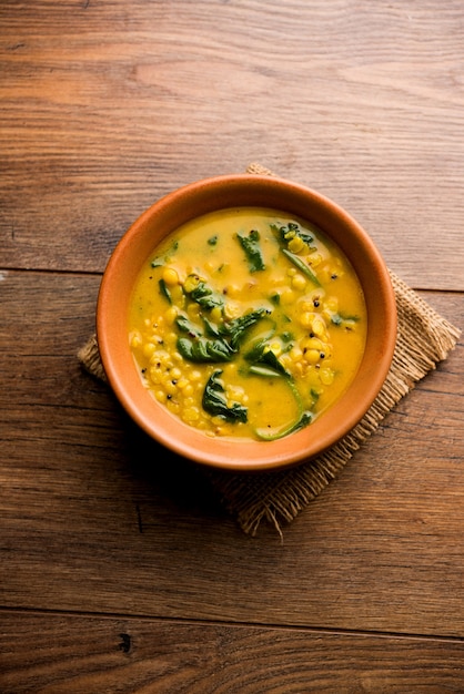 Dal Palak or Lentil spinach curry - popular Indian main course healthy recipe. served in a karahi or pan or bowl. selective focus