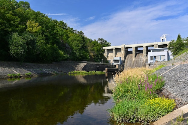 A dam on the Brno Reservoir by the Svratka River with a small power plant Beautiful sunny summer day in nature