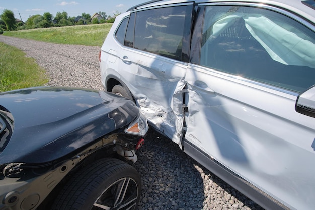 Damaged in heavy car accident vehicles after collision on city street crash site Road safety and insurance concept