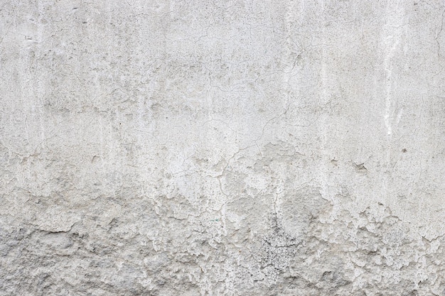 Damaged old concrete wall surface with crack lines