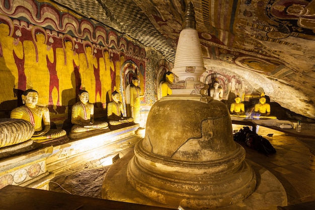 DAMBULLA, SRI LANKA - FEBRUARY 17, 2017: Stupa or dagoba and Buddha statues inside Dambulla Cave Temple. Cave Temple is a World Heritage Site near Dambulla city, Sri Lanka.