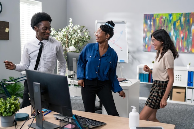 Dance at work office break from duties company party two girls and a man in a shirt and tie