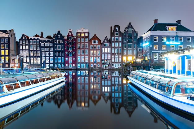 Dancing houses at Amsterdam canal Damrak Netherlands