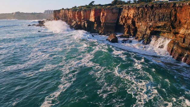 Dangerous rough coastal cliffs washed stormy ocean water aerial view huge waves