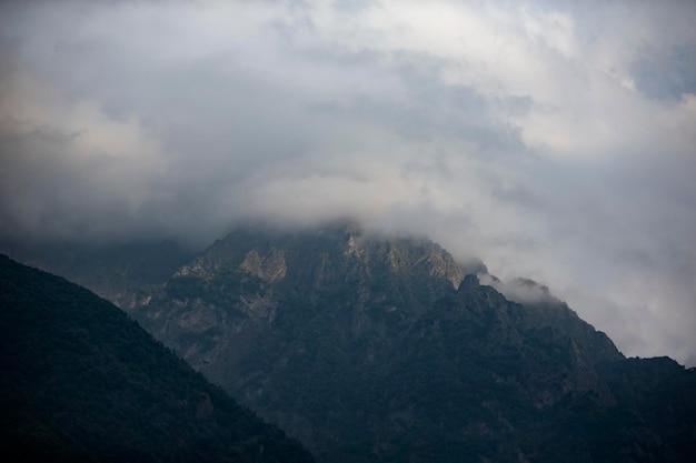 Dark atmospheric surreal landscape with a dark rocky mountain peak