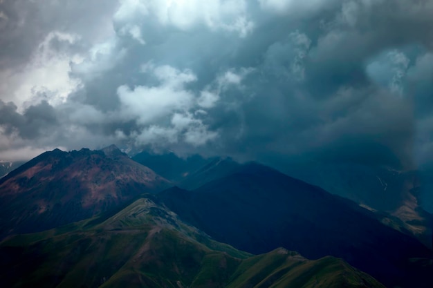 Dark atmospheric surreal landscape with a dark rocky mountain peak