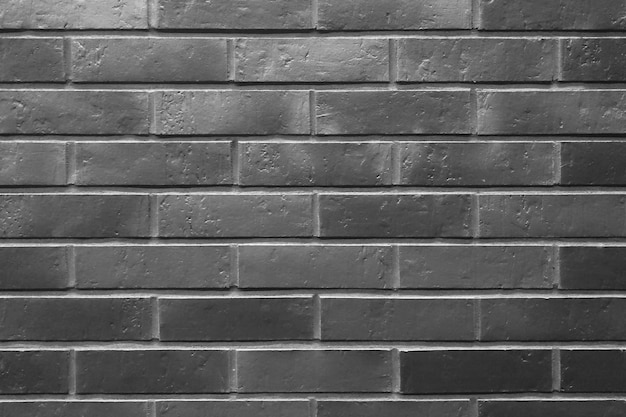 A dark background of brick walls of the building The texture of the brick