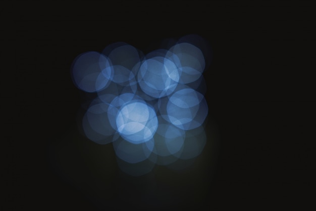 Dark blue bokeh abstract light background defocused