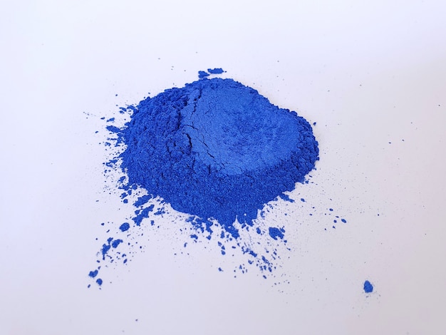 Dark blue mica pigmet powder on white background