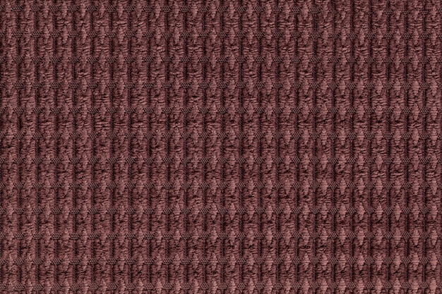 Dark brown background from soft fleecy fabric close up. Texture of textiles macro