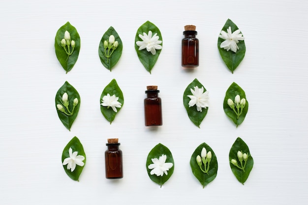 Dark brown Bottles of essential oil with jasmine flower