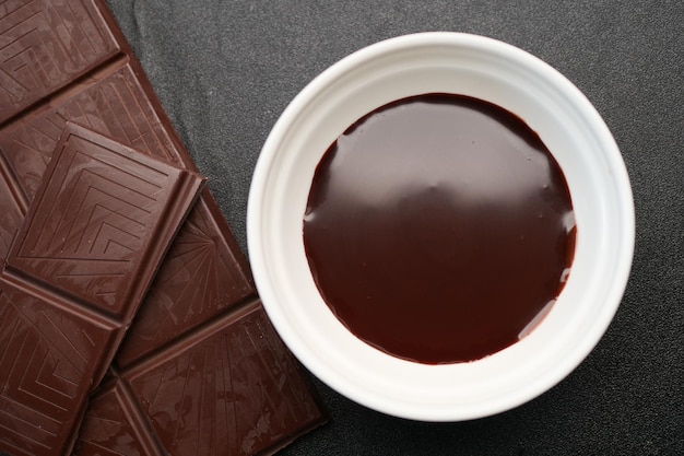 Dark chocolate cream in a bowl on white