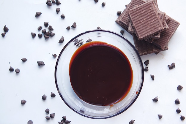 Dark chocolate cream in a bowl on white