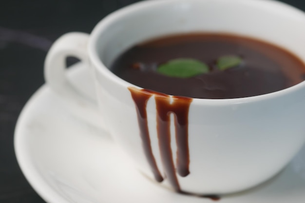 Dark chocolate cream in a coffee cup on table