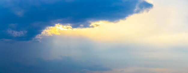 A dark cloud in the sunlit evening sky