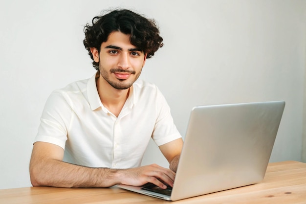 Dark eyed international student posing with white laptop