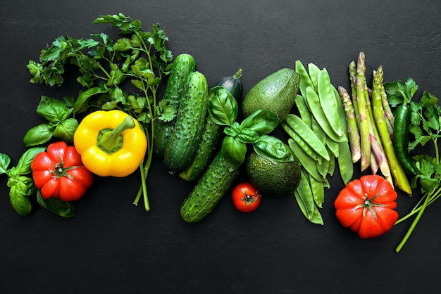 Dark flat lay culinary background with fresh produce, view from above