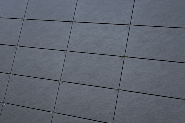 Dark gray tiled wall on building facade