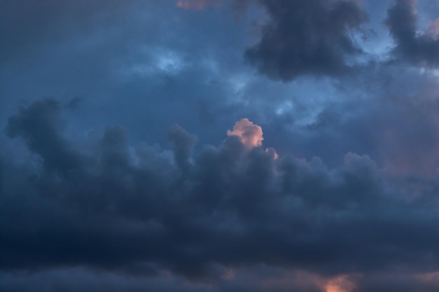 Dark gray and vanilla clouds at sunset