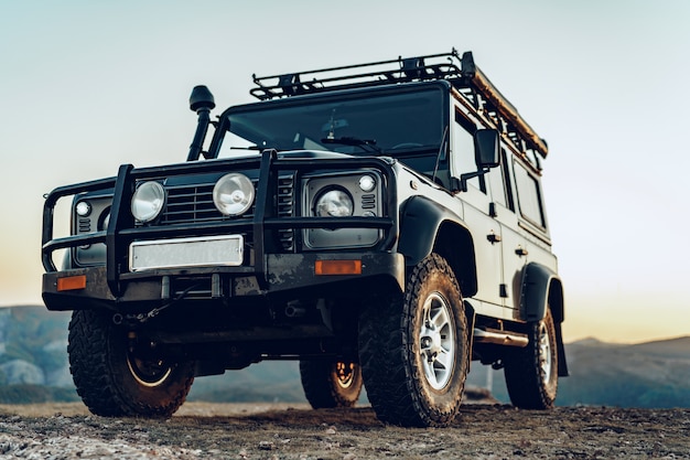 Dark green off-road car in the mountains